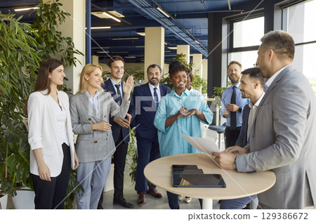 Group of business people in conference center lobby discussing issue Group of business people in conference center lobby discussing issue 129386672