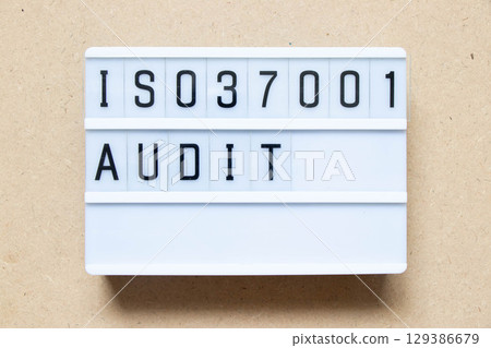 Lightbox with word ISO 37001 audit on wood background Lightbox with word ISO 37001 audit on wood background 129386679