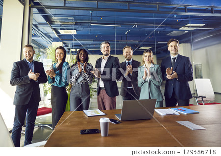 Business Team Applauding And Celebrating Success In Office Meeting Business Team Applauding And Celebrating Success In Office Meeting 129386718