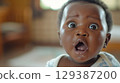 Adorable baby with big eyes and an open mouth - Generative AI 129387200