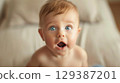 Adorable baby with big eyes and an open mouth - Generative AI 129387201