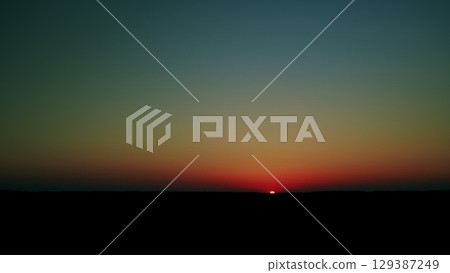 Witness the breathtaking sunset that paints the horizon with an array of vibrant colors 129387249