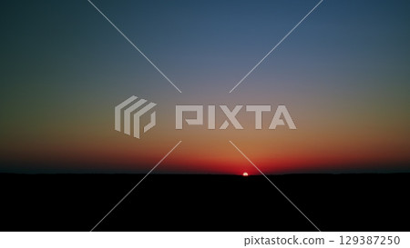 The Serene Sunset with Vibrant Gradients is Beautiful Over a Wondrous Horizon and Beyond The Serene Sunset with Vibrant Gradients is Beautiful Over a Wondrous Horizon and Beyond 129387250