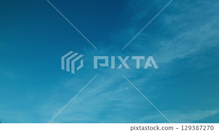 A Serene Blue Sky adorned with Soft Wispy Clouds that evoke a sense of peace and calmness A Serene Blue Sky adorned with Soft Wispy Clouds that evoke a sense of peace and calmness 129387270