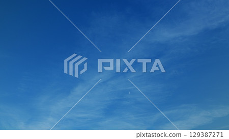 Serene blue skies adorned with wispy clouds provide a calming aesthetic for all Serene blue skies adorned with wispy clouds provide a calming aesthetic for all 129387271