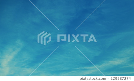 A Beautiful Blue Sky adorned with Wispy Clouds, creating a stunning visual masterpiece A Beautiful Blue Sky adorned with Wispy Clouds, creating a stunning visual masterpiece 129387274