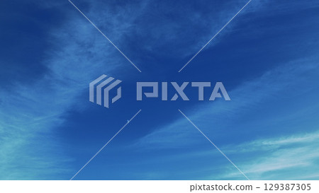 A Beautiful Serene Blue Sky Filled with Wispy Clouds and a Celestial Accent Above Us 129387305