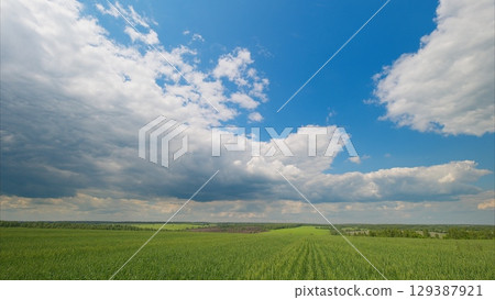 A Beautiful and Scenic Sky Over Lush Green Fields of Vibrant Nature and Idyllic Countryside 129387921