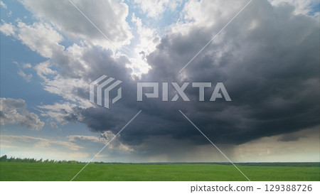 A Dramatic and Captivating Cloudscape Displaying Beautiful Views Over Lush Green Fields A Dramatic and Captivating Cloudscape Displaying Beautiful Views Over Lush Green Fields 129388726