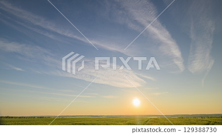 Experience a serene sunrise over verdant fields, a breathtaking landscape of beauty and calm Experience a serene sunrise over verdant fields, a breathtaking landscape of beauty and calm 129388730