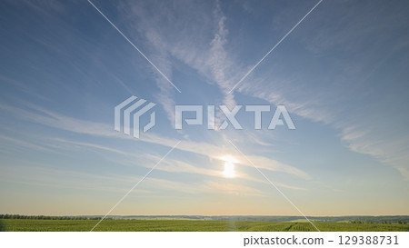A Serene Sunrise Appears Over a Calm and Tranquil Horizon, Creating a Beautiful Scene 129388731