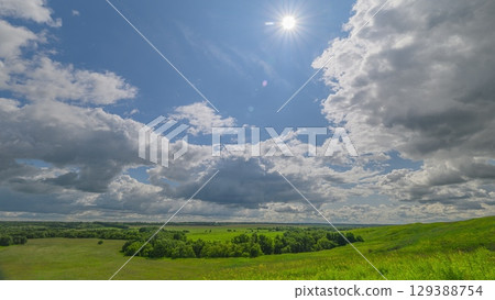 A Serene and Beautiful Landscape Featuring Dramatic Clouds Alongside Lush Green Fields A Serene and Beautiful Landscape Featuring Dramatic Clouds Alongside Lush Green Fields 129388754
