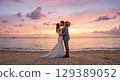 bride and groom on the beach at sunset 129389052