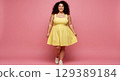 young smiling woman in yellow dress 129389184