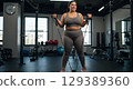 sexy athletic young girl training arms in gym 129389360