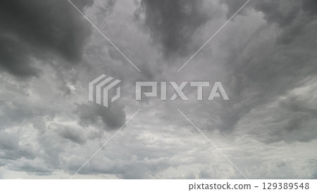 A Dramatic Gray Cloudy Sky with Intricate Swirling Patterns Creating a Striking Visual A Dramatic Gray Cloudy Sky with Intricate Swirling Patterns Creating a Striking Visual 129389548