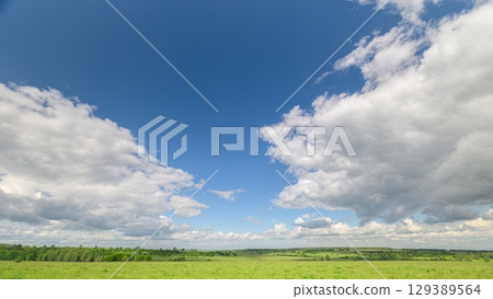 Breathtaking Scenic Sky and Verdant Green Fields Under Stunning Dramatic Cloudscape Breathtaking Scenic Sky and Verdant Green Fields Under Stunning Dramatic Cloudscape 129389564