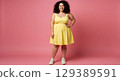 the young woman in a yellow dress with pink background 129389591