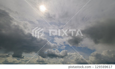 A dynamic cloudscape with brilliant sunlight creates a stunning visual experience of calm 129389617