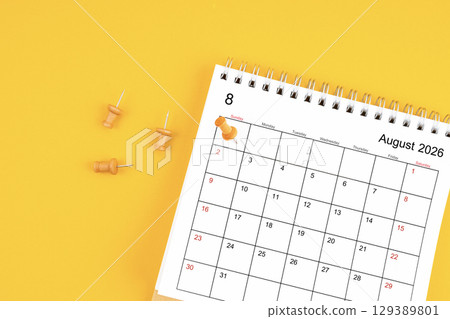 August 2026 Monthly desk calendar for 2026 year with wooden pin on yellow background. 129389801