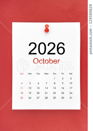 October 2026 calendar page with push pin on red color background. 129389829