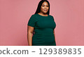 portrait of a big size model with pink background 129389835