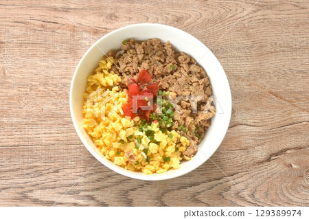 fried chop chicken and sweet egg toppiing red pickled cucumber on rice or tori soboro don japanese food in bowl 129389974