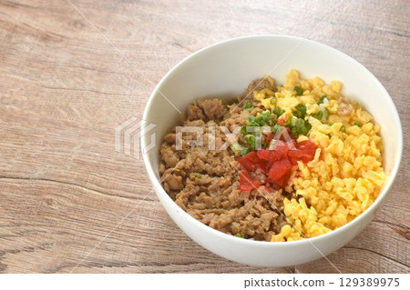 fried chop chicken and sweet egg toppiing red pickled cucumber on rice or tori soboro don japanese food in bowl 129389975