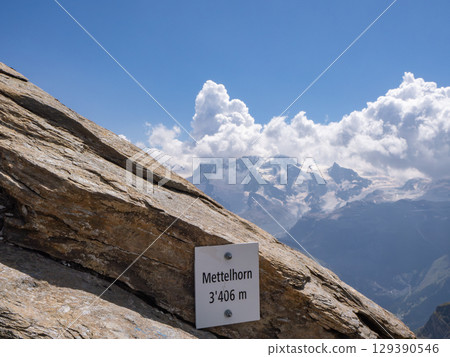 Mettelhorn, Switzerland - August 24th 2024: Arrival at the summit, the 2nd highest Swiss peak with a hiking trail 129390546