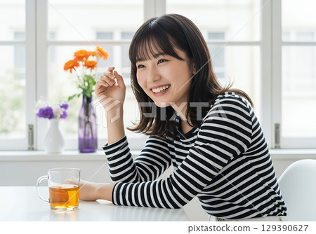 A young woman enjoying tea time 129390627