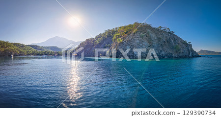 Wonderful Paradise bay of Camyuva, Kemer, Turkey. Scenery sea view to the coast with boats on the blue water. Summertime holiday seascape 129390734