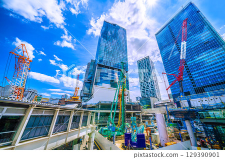 Tokyo cityscape, Japan, August 8th. Extremely hot... Huge heavy machinery such as piledrivers lined up... Towards a new chapter... = Shibuya 129390901
