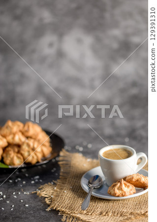 Homemade coconut cookies on a gray background. Healthy food concept. Copy space. For advertising confectionery products 129391310