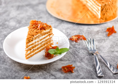 Honey cake. Homemade baking concept. Slit and slice of cake. Homemade layered honey cake 129391314