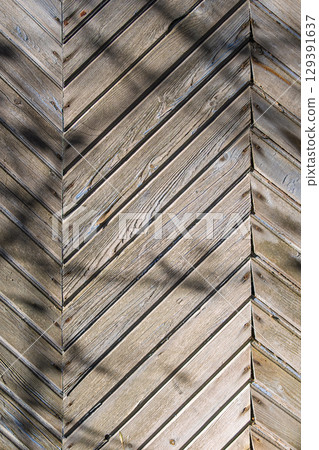 A beautifully crafted Textured Wooden Chevron Pattern showcased in the warm embrace of Natural Light 129391637