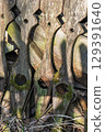 Artistic Wooden Fence Featuring Intricate Designs and Captivating Shadows All Around It 129391640