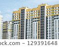 A modern residential complex featuring a vibrant and colorful facade that captures attention 129391648