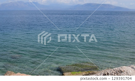 Coastline views of Greece showcasing clear blue waters and rocky shores offering tranquil escape and natural beauty for relaxation and exploration Coastline views of Greece showcasing clear blue waters and rocky shores offering tranquil escape and natural beauty for relaxation and exploration 129391704