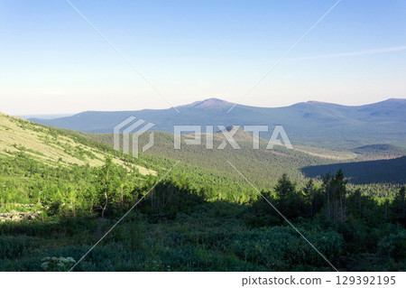 mountain landscape of the Northern Urals, view of a wooded valley from a slope mountain landscape of the Northern Urals, view of a wooded valley from a slope 129392195