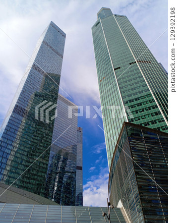 Modern skyscrapers on a blue sky background Modern skyscrapers on a blue sky background 129392198