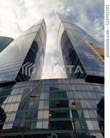 Modern skyscrapers on a blue sky background Modern skyscrapers on a blue sky background 129392201