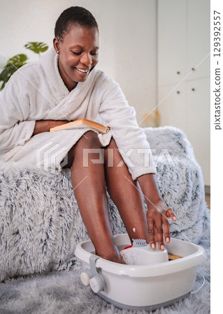 Serene moment of self-care with a foot spa and a good book Serene moment of self-care with a foot spa and a good book 129392557