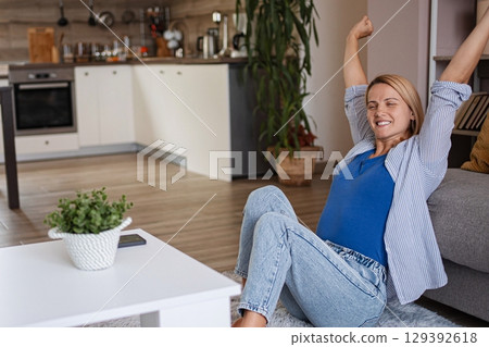 Pregnant Woman Stretching on Living Room Floor 129392618