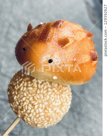 Deep fried hedgehog bread and sesame dumpling skewers Deep fried hedgehog bread and sesame dumpling skewers 129392627