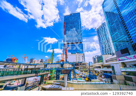 Tokyo cityscape, Japan, August 8th. Extremely hot... Huge heavy machinery such as piledrivers lined up... Towards a new chapter... = Shibuya Tokyo cityscape, Japan, August 8th. Extremely hot... Huge heavy machinery such as piledrivers lined up... Towards a new chapter... = Shibuya 129392740