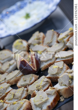 Foie gras and fig toast served as a delightful aperitif in an outdoor setting during a sunny 129392961