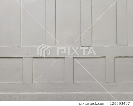Plain white wooden wall with vertical and horizontal panels smooth surface simple background neutral color indoor setting minimal texture clean Plain white wooden wall with vertical and horizontal panels smooth surface simple background neutral color indoor setting minimal texture clean 129393497