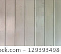 Close up of painted wooden wall panels with vertical grooves, smooth surface, and subtle color variations creating calm and neutral background 129393498