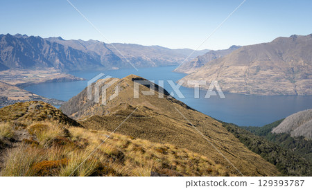 Beautiful alpine autumnal landscape with mountain ridges and lake nested between them, New Zealand 129393787