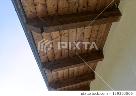 the pitch of a roof with wooden beams 129393806